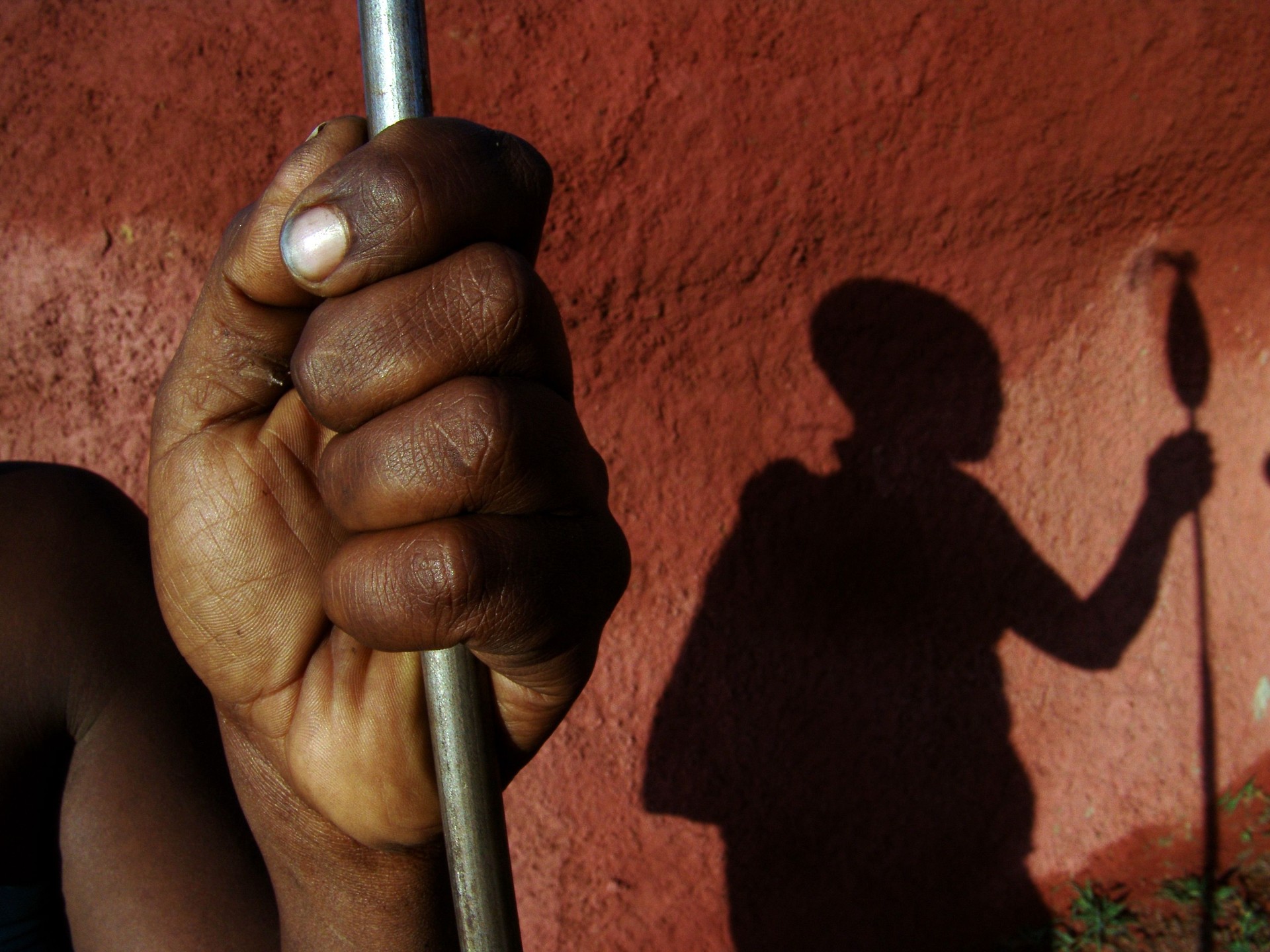 Samburu warrior  with a spear shadowed in the redish wall